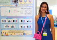 Sara Cartan standing by a scientific poster